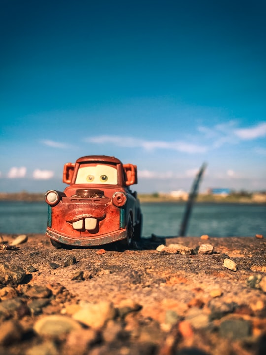 red volkswagen beetle on shore during daytime in Gampong Jawa Indonesia