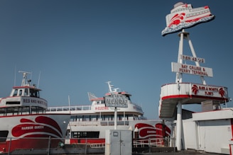white and red ship under blue sky during daytime