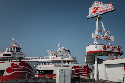 white and red ship under blue sky during daytime