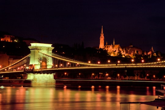green bridge with lights during night time in Széchenyi Chain Bridge Hungary