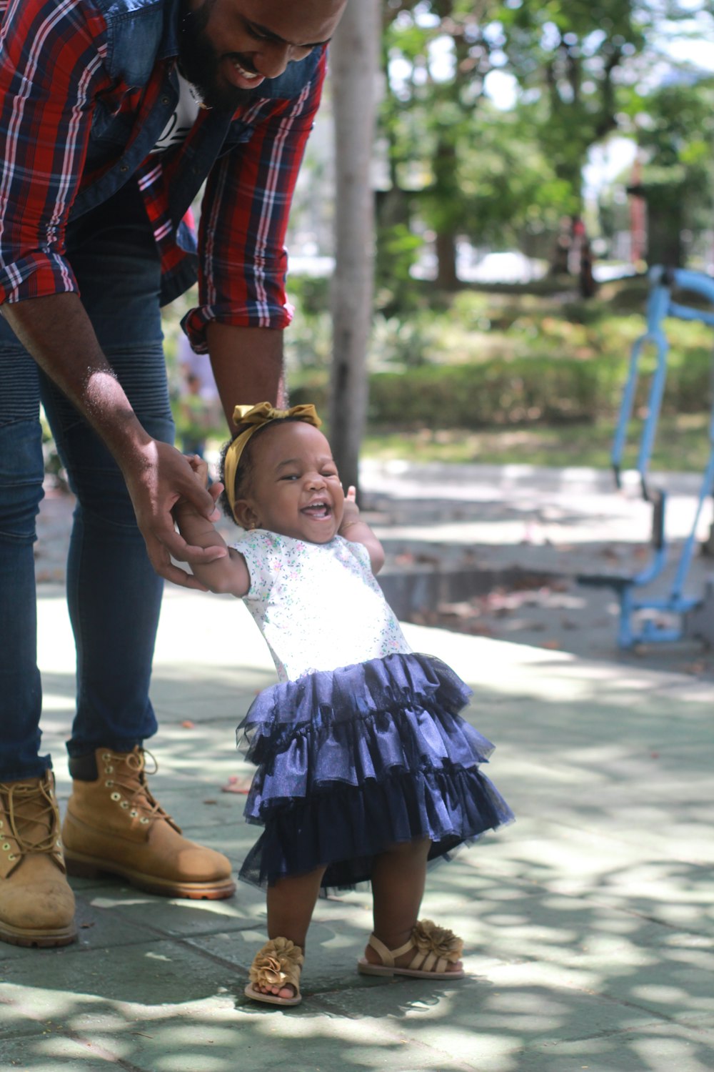 man in red and black plaid dress shirt carrying girl in white dress