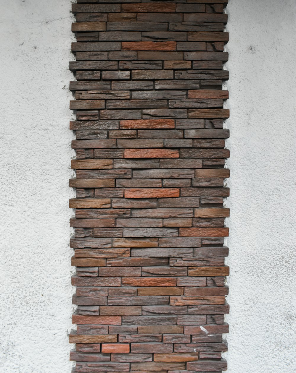 brown brick wall on white concrete wall