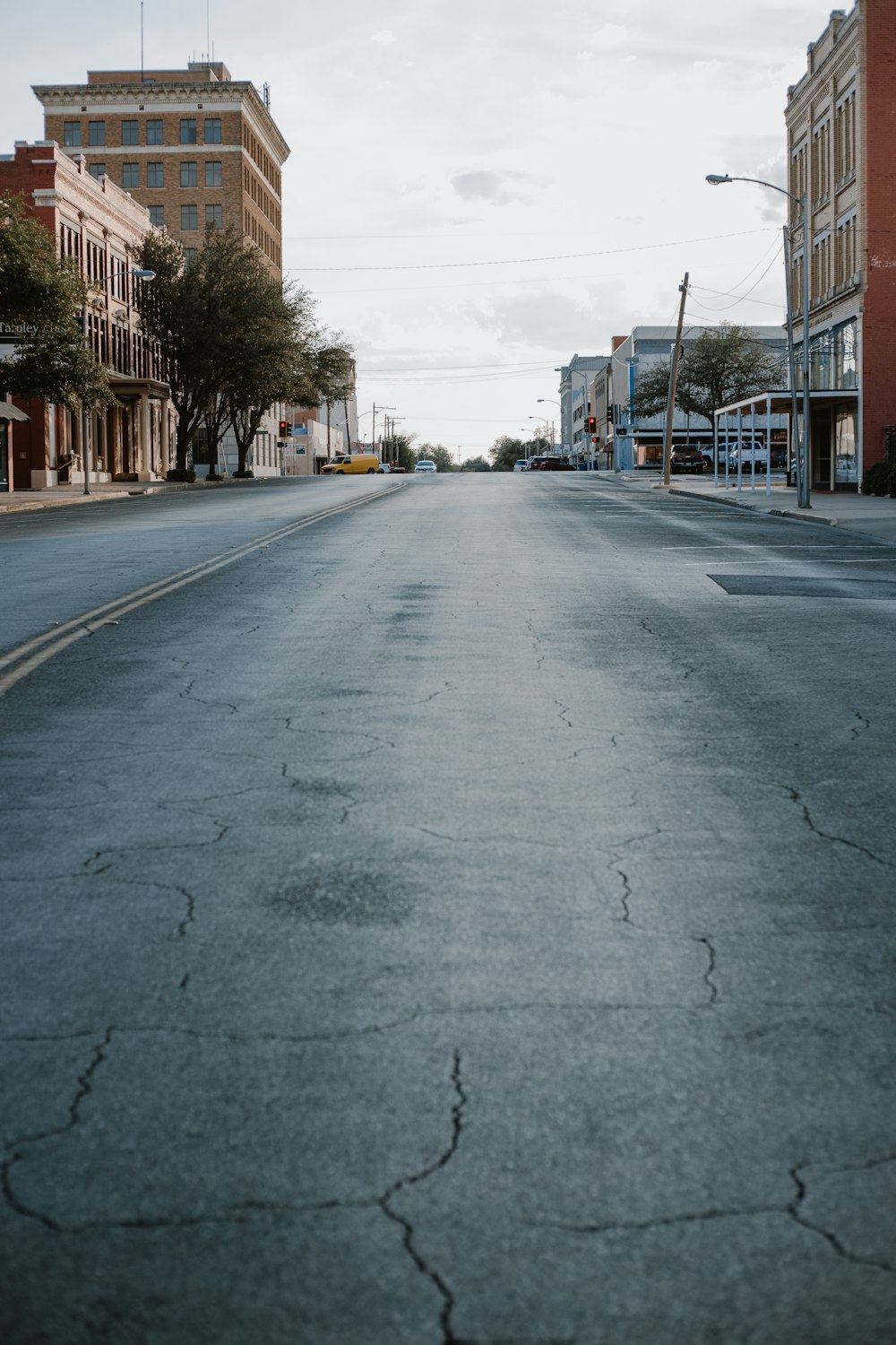 gray concrete road with cars parked on side during daytime