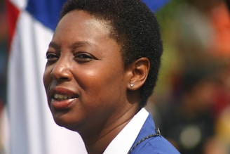 Portrait of Pat Ferdig in a navy blue blazer with a turquoise accent background.