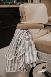 white and black textile on beige leather chair