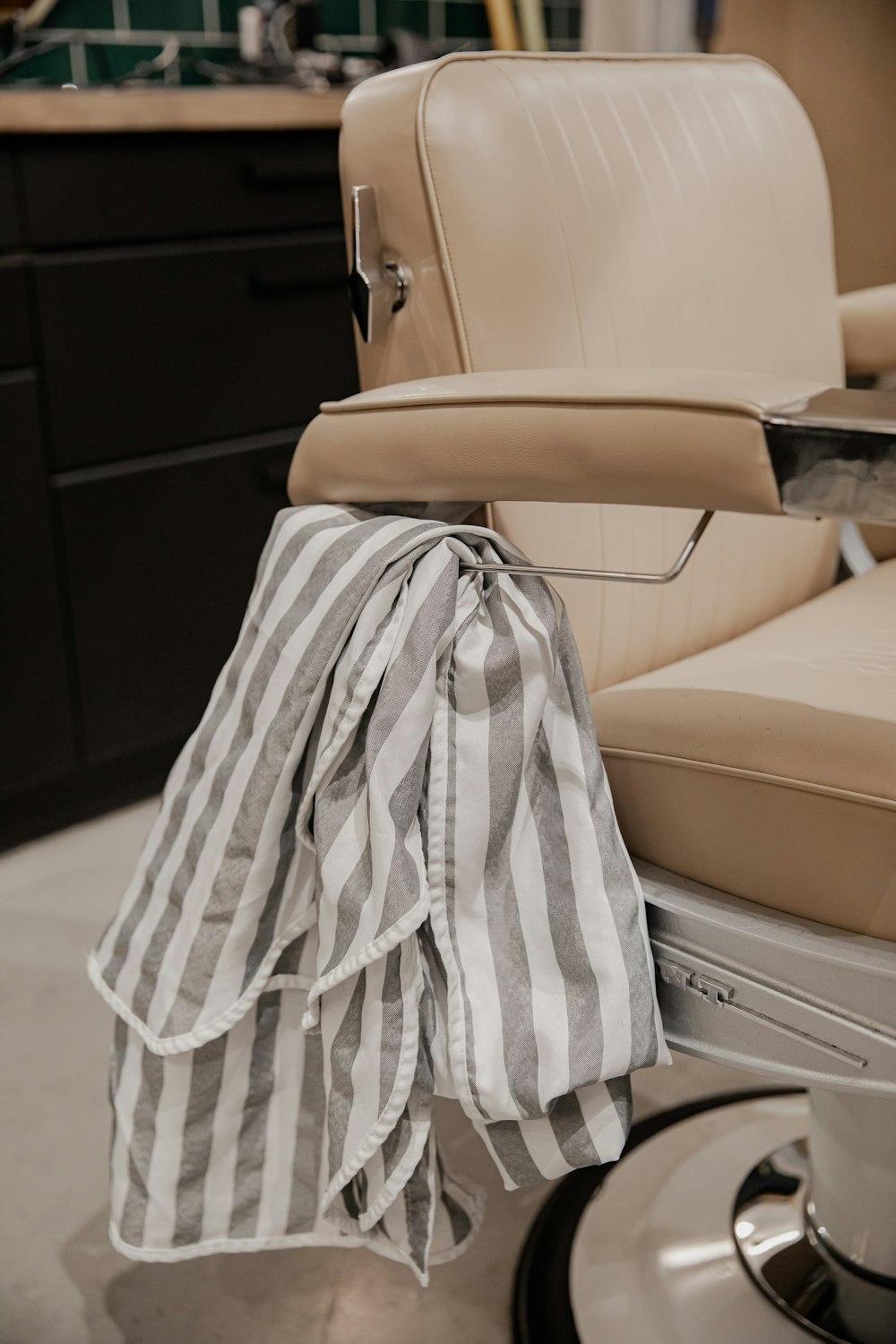 white and black textile on beige leather chair