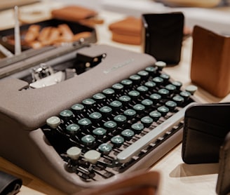 black typewriter on brown wooden table