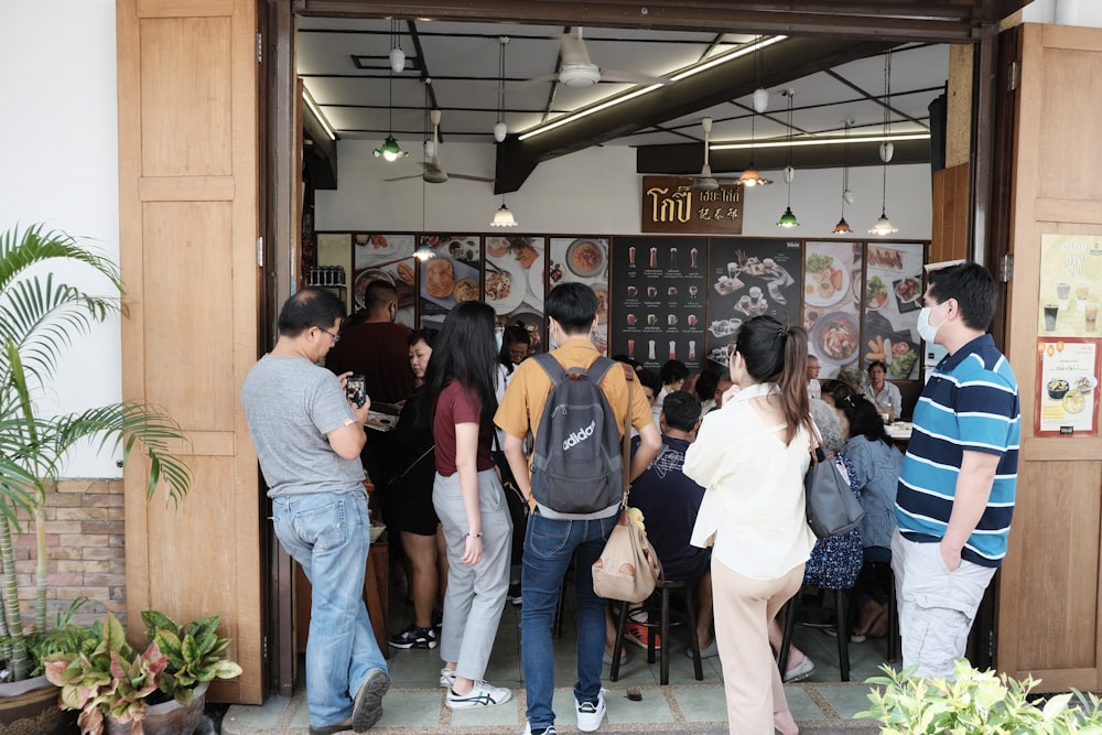 people standing in front of brown wooden counter