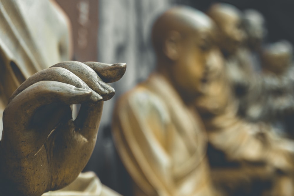 gold statue of man and woman