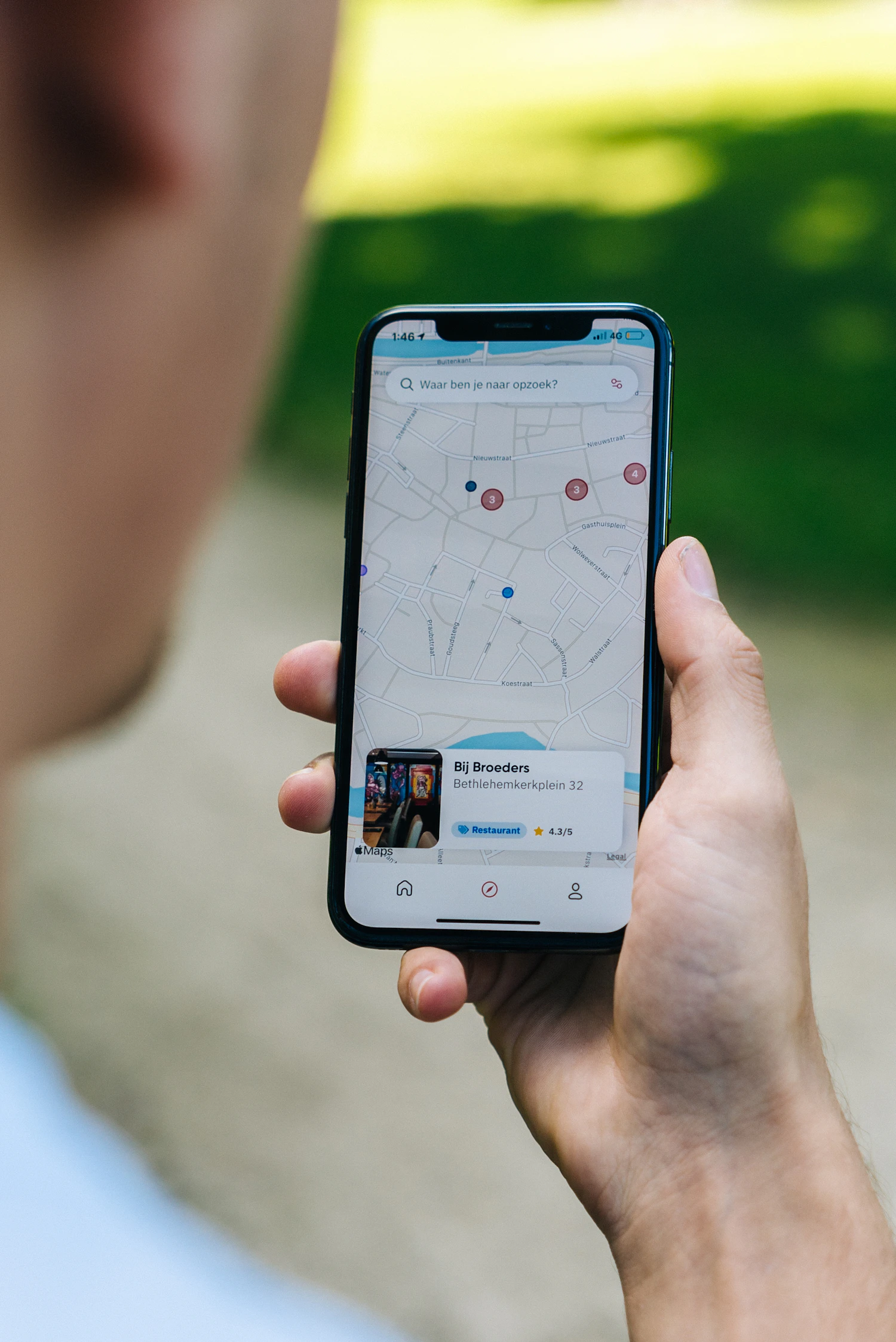 Person holding a smartphone with a navigation map open