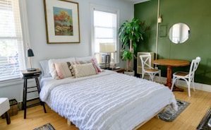 white bed linen on bed