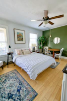 A cozy bedroom showcasing colorful accent walls and pristine drywall installation.