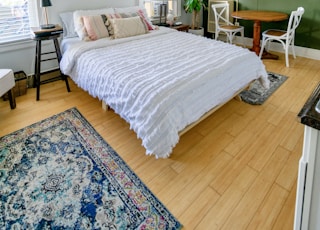 white bed linen on bed