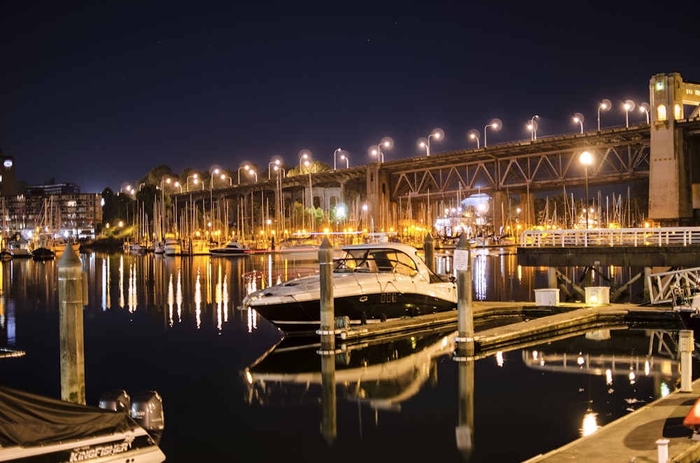 white and black boat on dock during night time