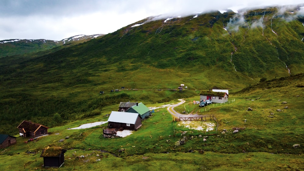 green grass field and house on top of hill