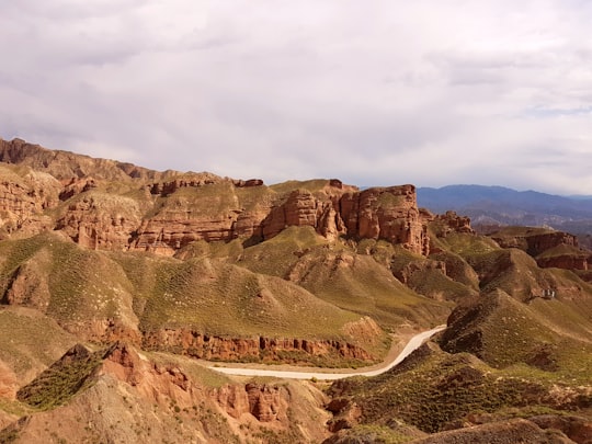 brown rocky mountain under white cloudy sky during daytime in Zhangye China