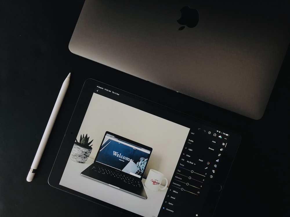 silver ipad on black table