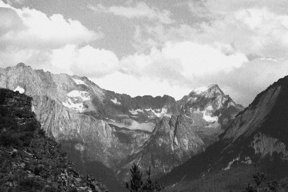 grayscale photo of mountains and clouds