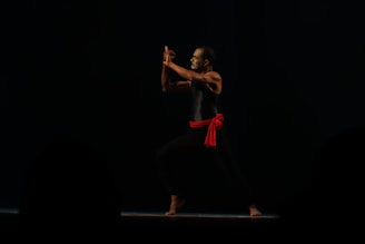 A dynamic silat martial artist performing a traditional move.