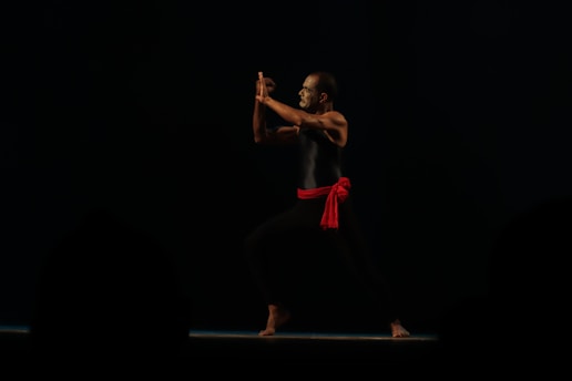 A dynamic silat martial artist performing a traditional move.