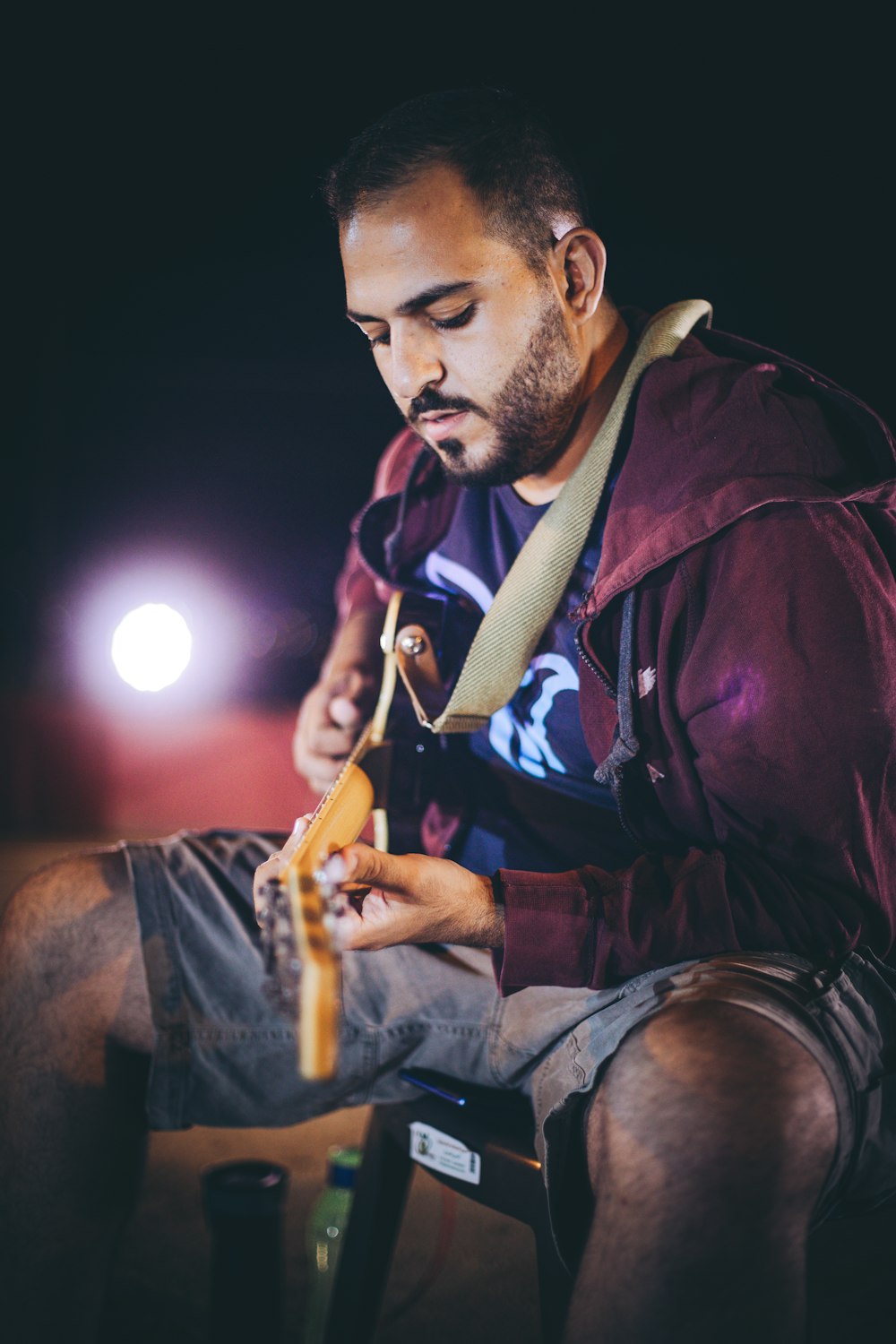 man in red jacket smoking cigarette