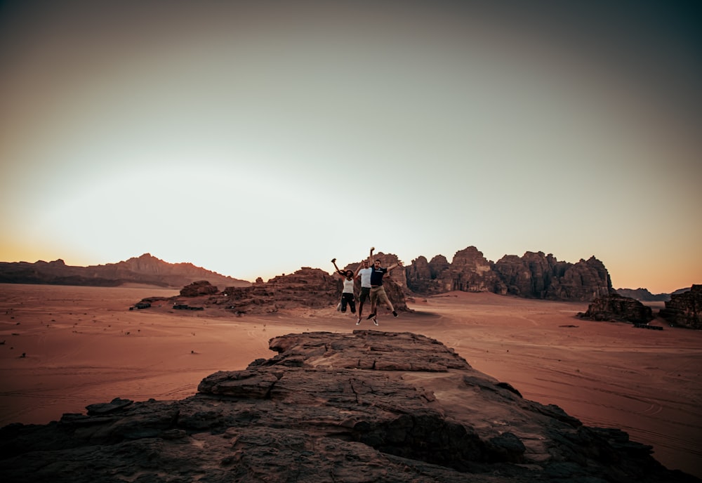 people riding horses on brown sand during daytime