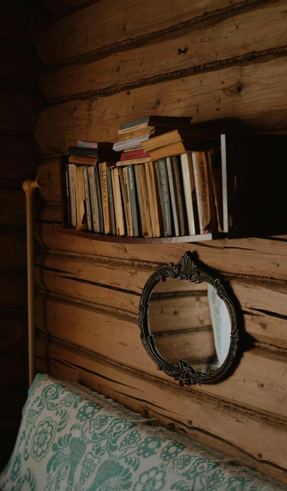 black and silver round watch on brown wooden shelf