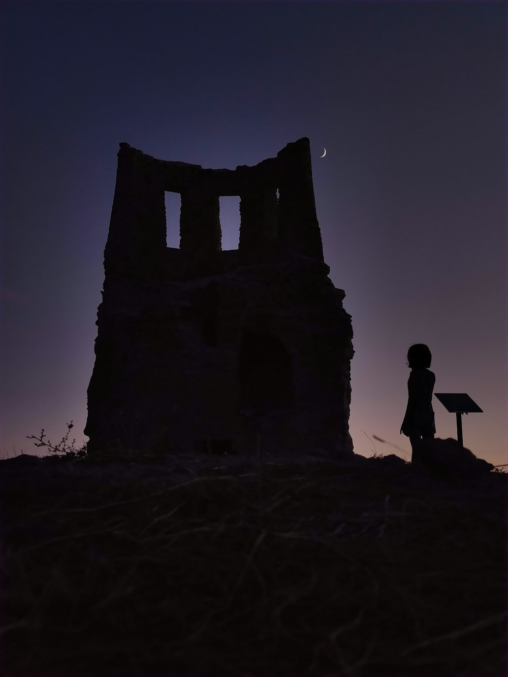 silhouette of man standing on top of a building