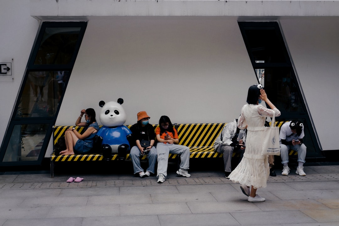 children sitting on yellow and blue train toy