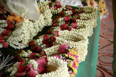Beautiful temple garlands made with jasmine and marigold flowers, ready for offering.
