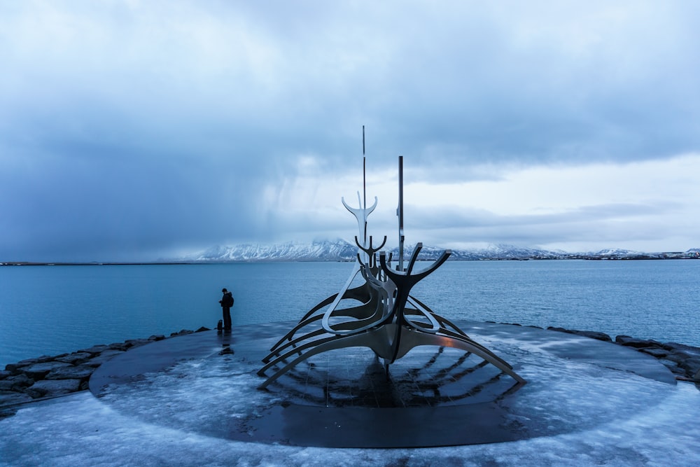 black metal bird statue on water