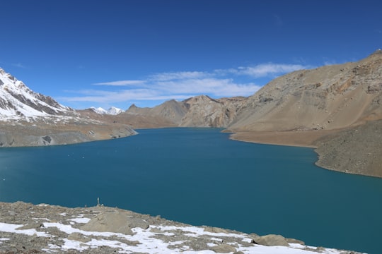 blue lake in the middle of the mountains in Tilicho Lake Nepal