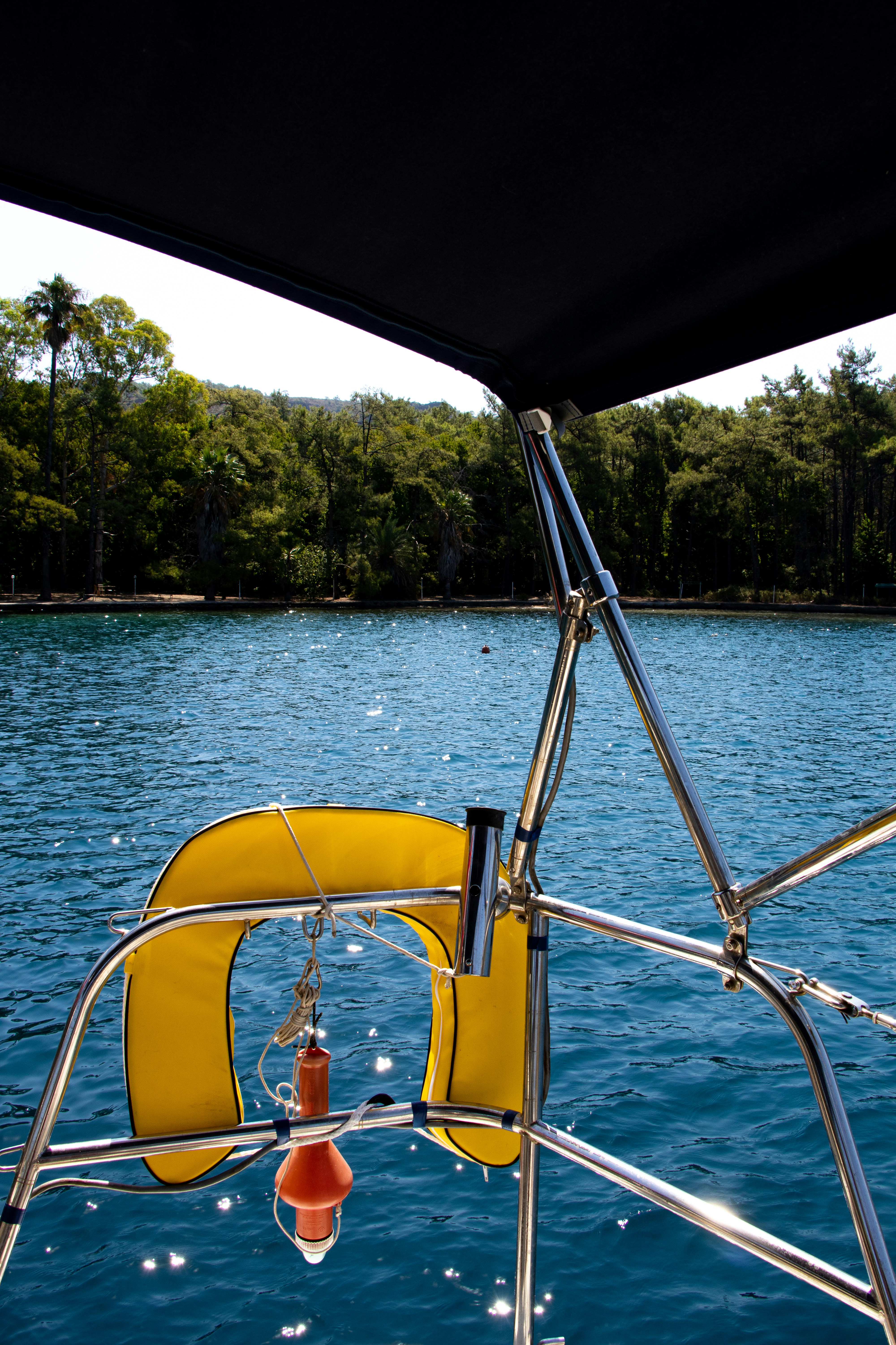 yellow and black boat on blue sea during daytime