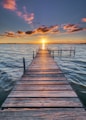 brown wooden dock on sea during sunset