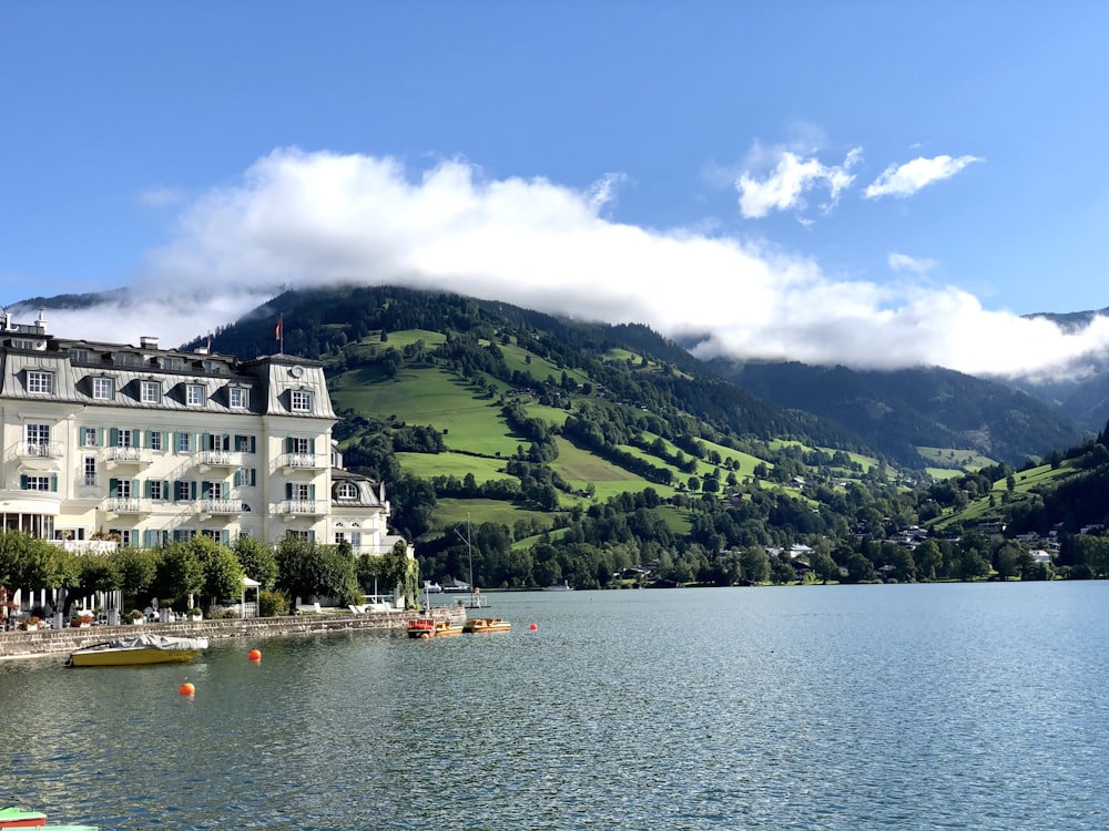 edificio in cemento bianco e marrone vicino allo specchio d'acqua durante il giorno