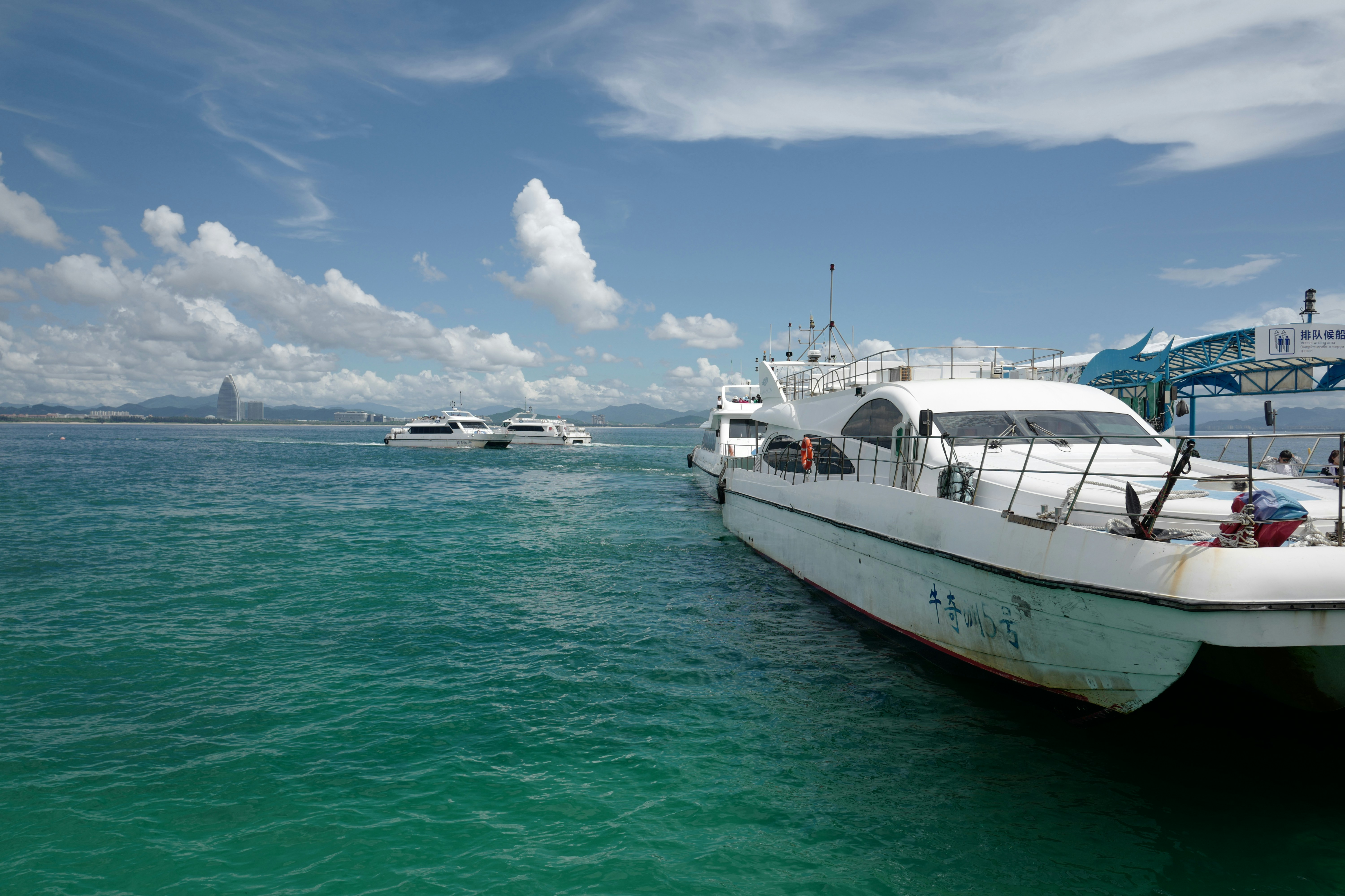 White Boat On Sea Under Blue Sky And White Clouds During Daytime