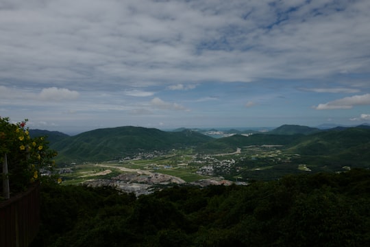 green mountains under white clouds during daytime in Sanya China