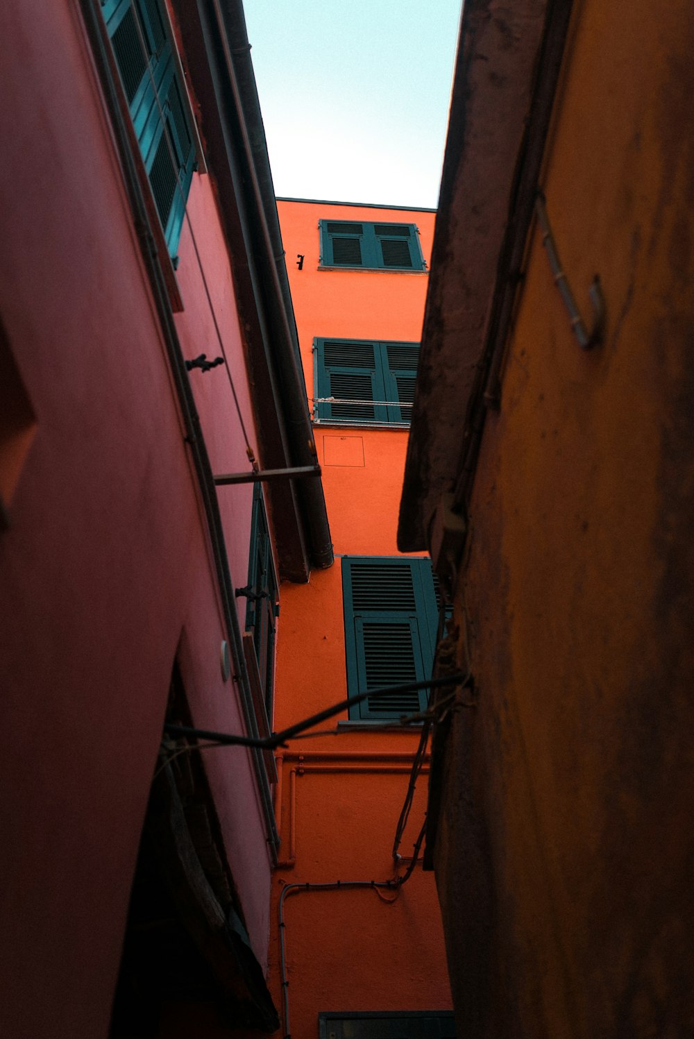 Klimaanlage mit blauem Fenster auf orangefarbenem Betongebäude
