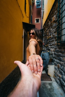 photography poses for women,how to photograph follow me; woman in black and white dress holding her hand