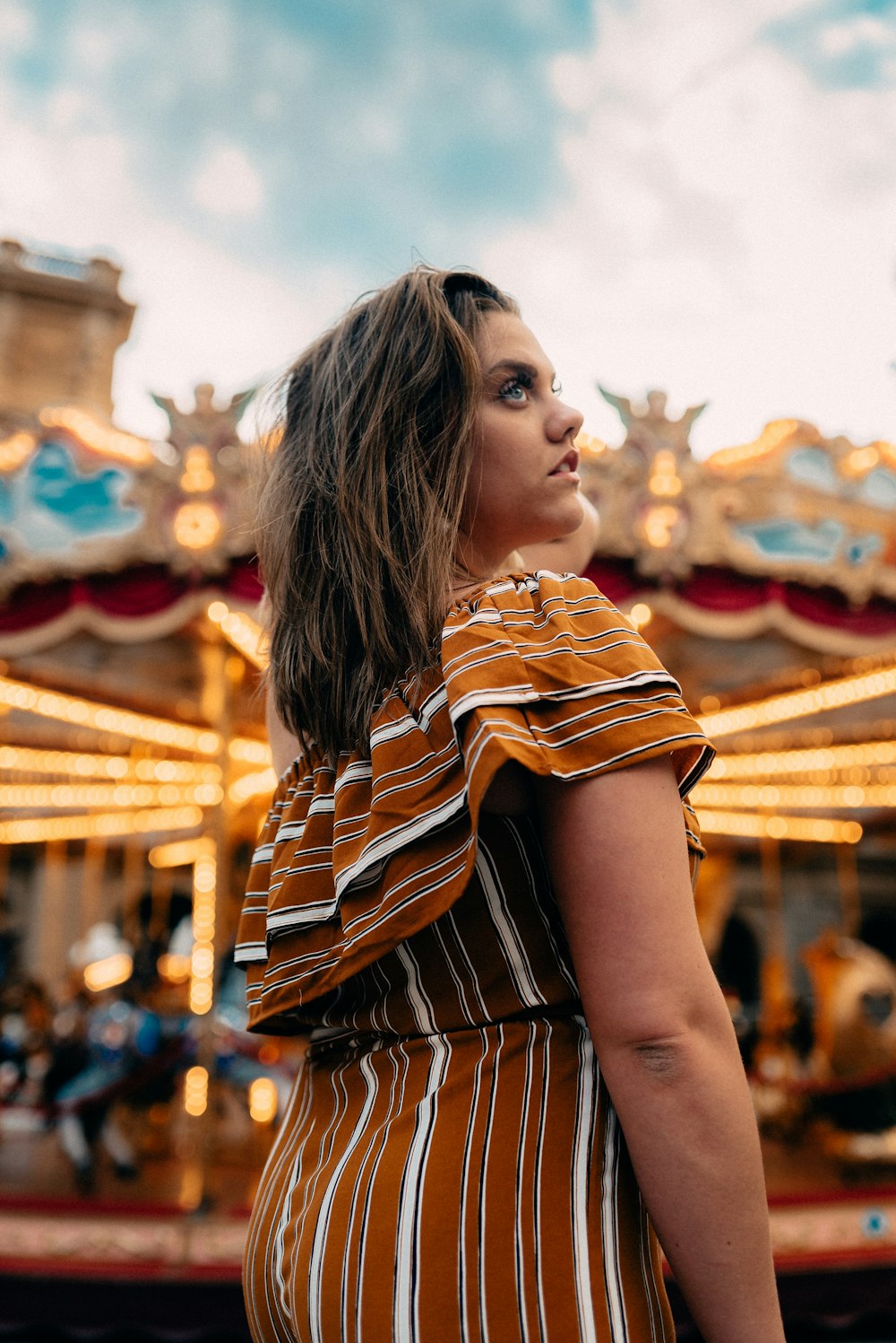 woman in brown and white stripe shirt standing during daytime