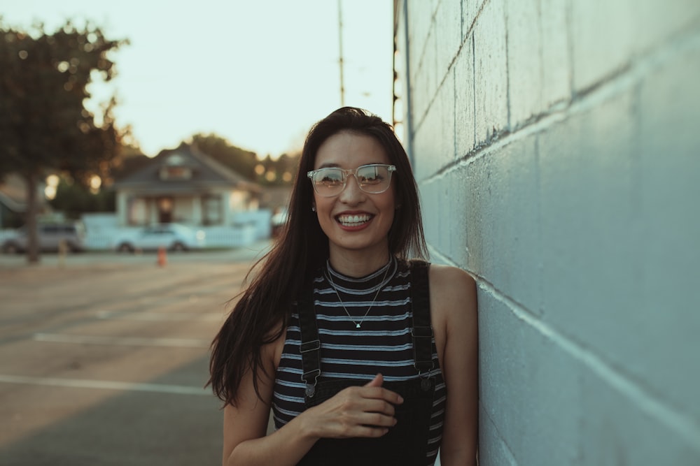 woman in black and white striped tank top wearing black framed eyeglasses