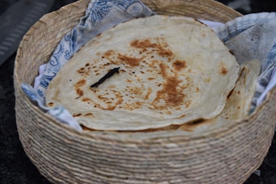 brown bread on white wicker basket pancake teams background