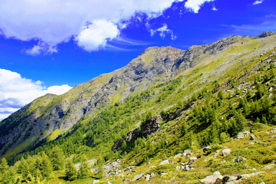 green mountains under blue sky during daytime in Puy-Saint-Vincent France