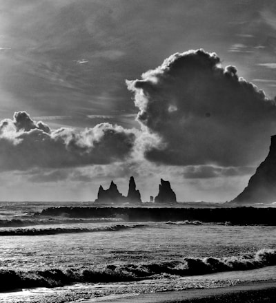 grayscale photo of sea waves crashing on shore