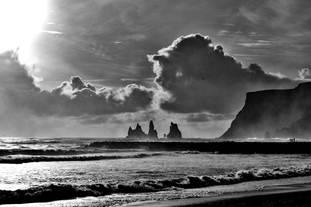 grayscale photo of sea waves crashing on shore