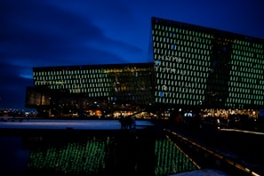 A dynamic video still of a property’s exterior with aqua green lighting highlights.