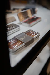Elegant navy blue and charcoal colored packaging lids arranged neatly on a white surface.
