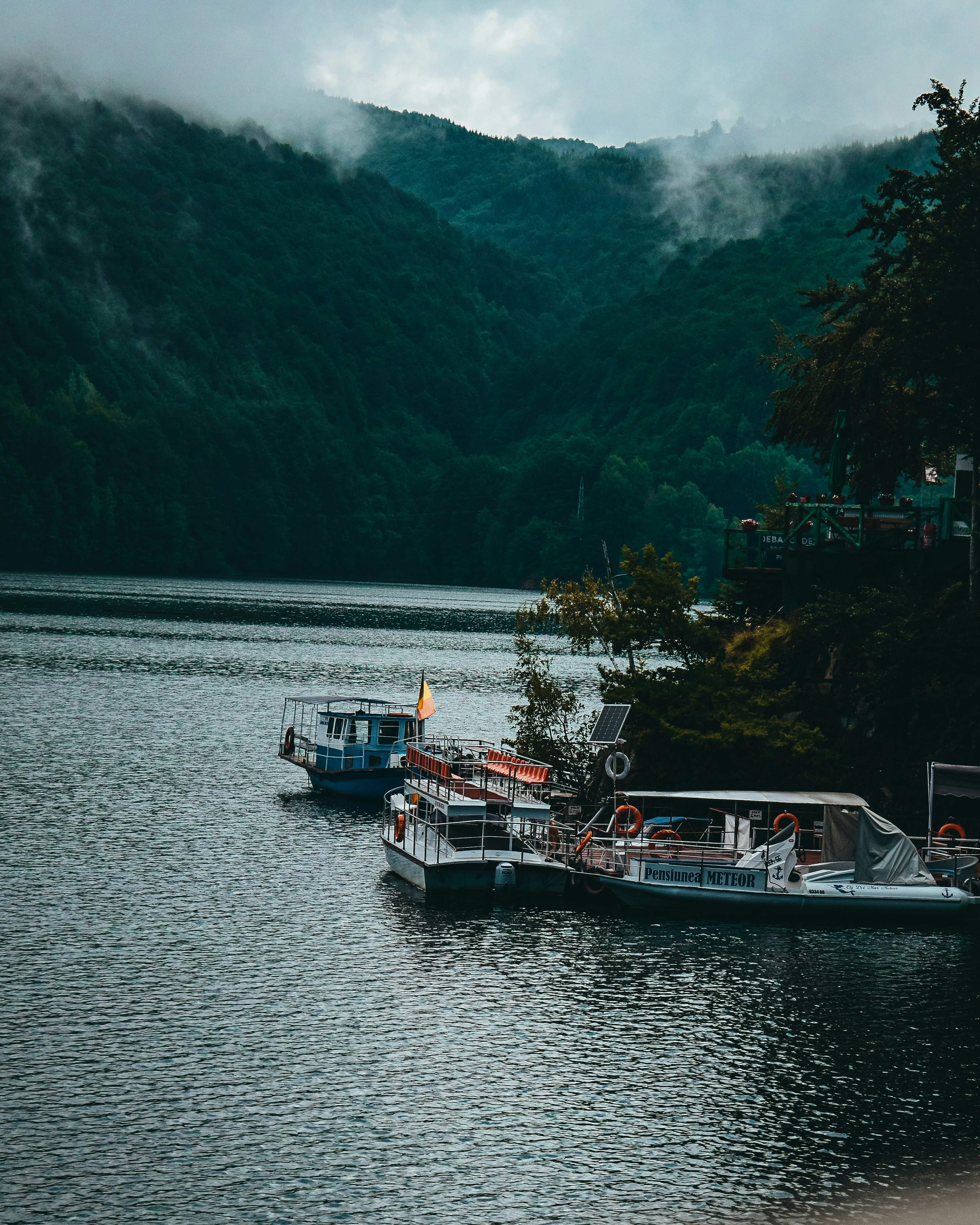 white and blue boat on body of water during daytime
