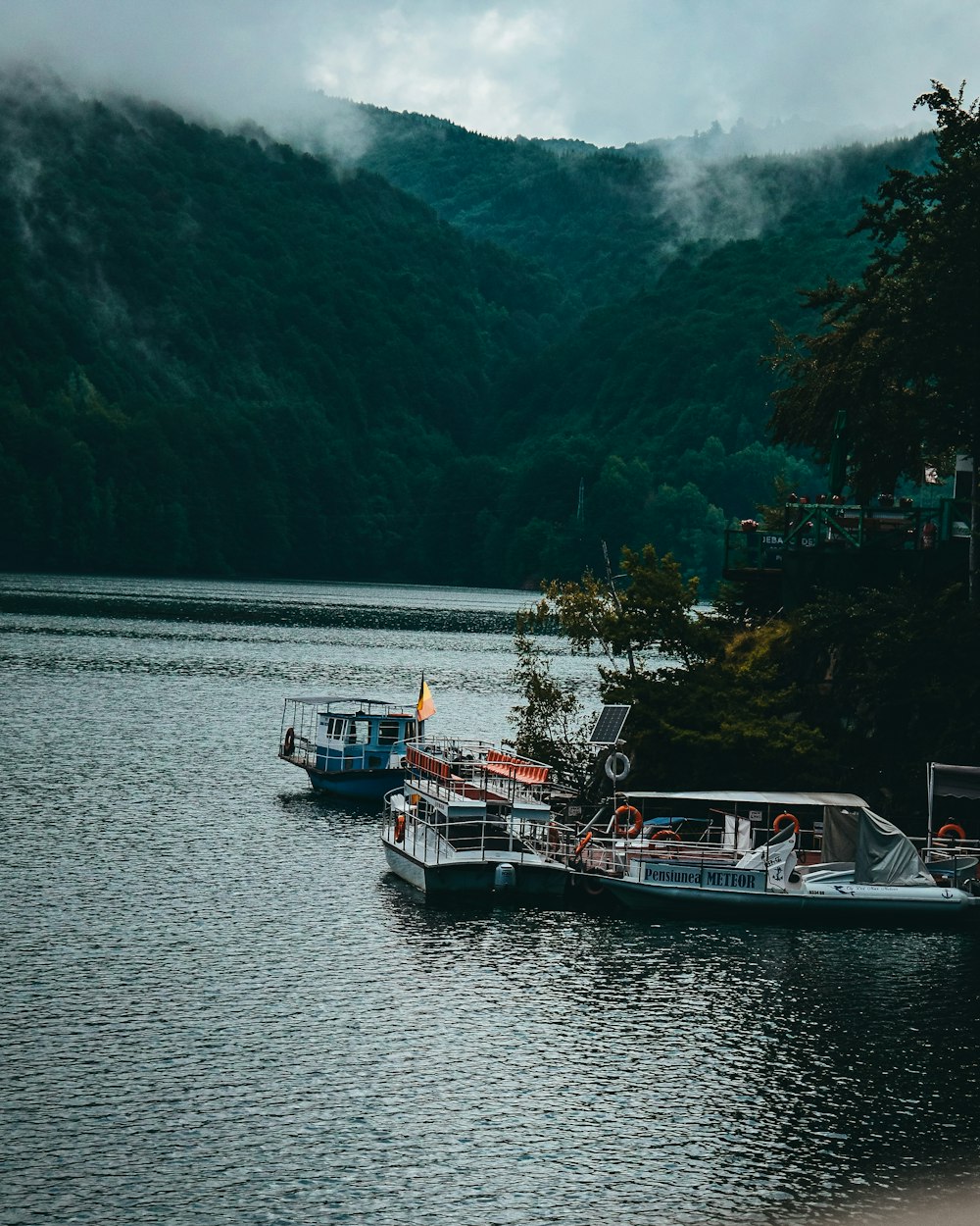 white and blue boat on body of water during daytime