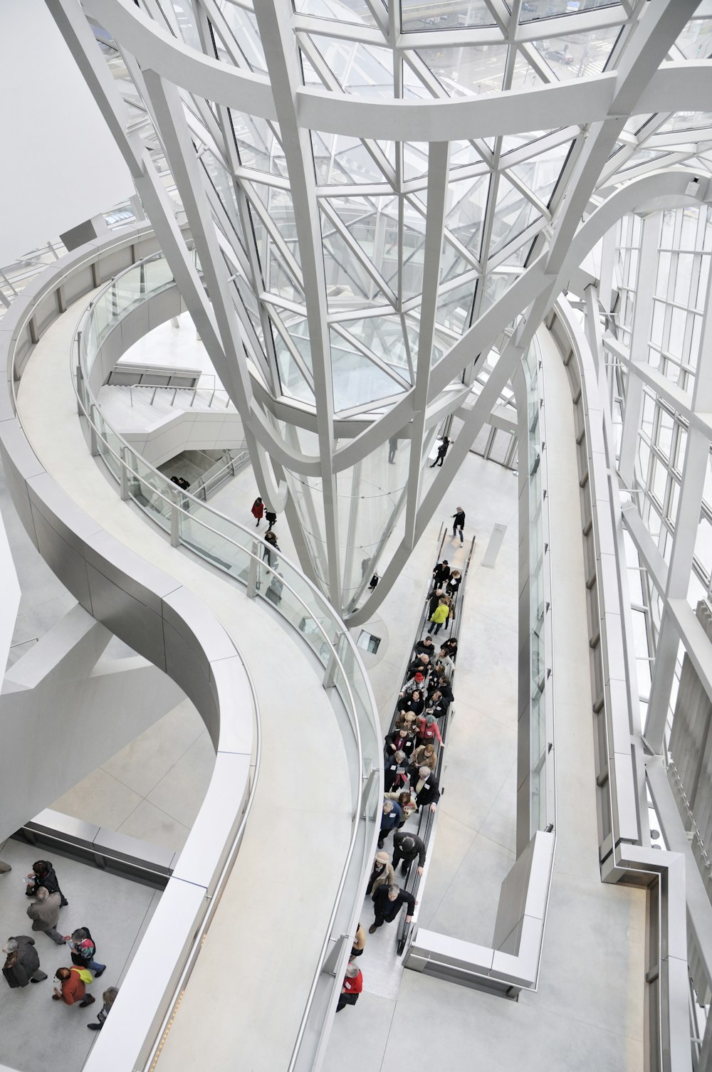 people walking on white spiral staircase